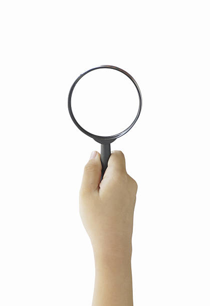 istock hand holding magnifier isolated on white background 636937064