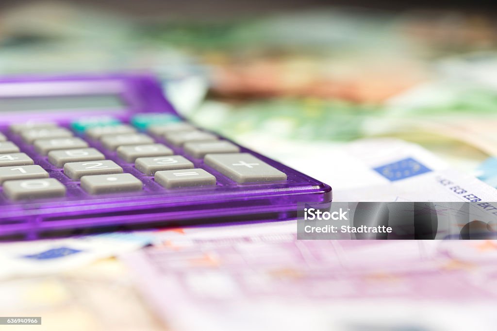 Euro banknotes and calculators A calculator and many euro banknotes Business Stock Photo