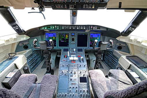 Photo of the cockpit of a modern corporate aircraft featuring glass cockpit instrumentation.