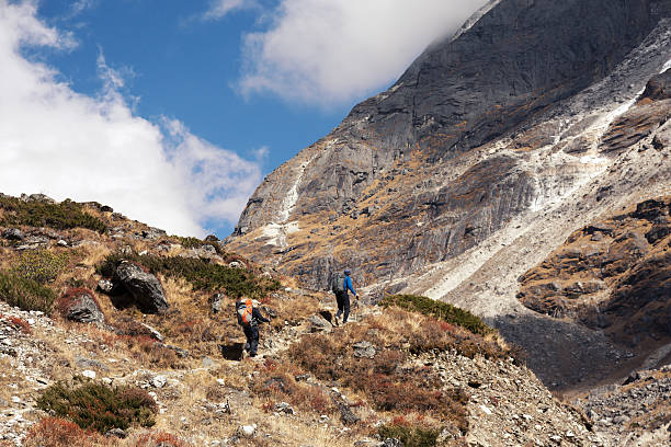 istock Group of Hikers walking up on Mountain Trail towards Pass 636943306