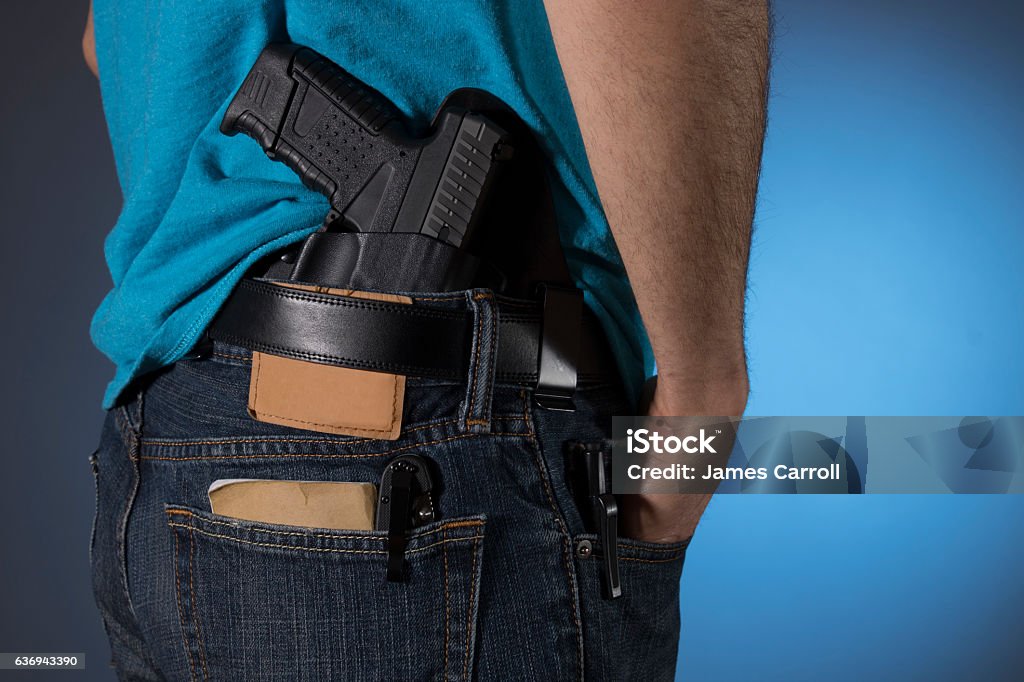 Man with everyday carry items (EDC) Man with a variety of everyday carry (edc) items; a gun, notes, pocket knife, and flashlight Concealed Carry Stock Photo