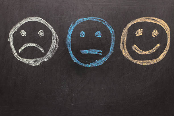 istock Drawing Unhappy and Happy Smileys on Blackboard 636946694