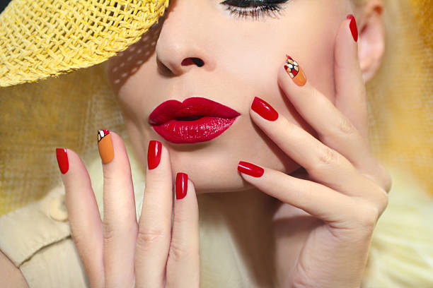 Red straw nail design. Red straw nail design girl model with red lips and a straw hat on his head. red nail polish stock pictures, royalty-free photos & images