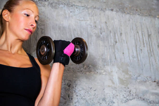Woman holding dumbbells for fitness outdoors