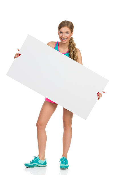istock Smiling Woman Holding Blank Placard 636951740