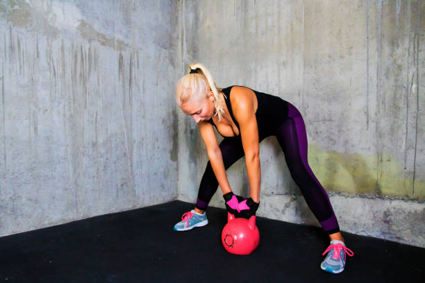 istock Woman exercise with kettle bell - gym workout 636952172