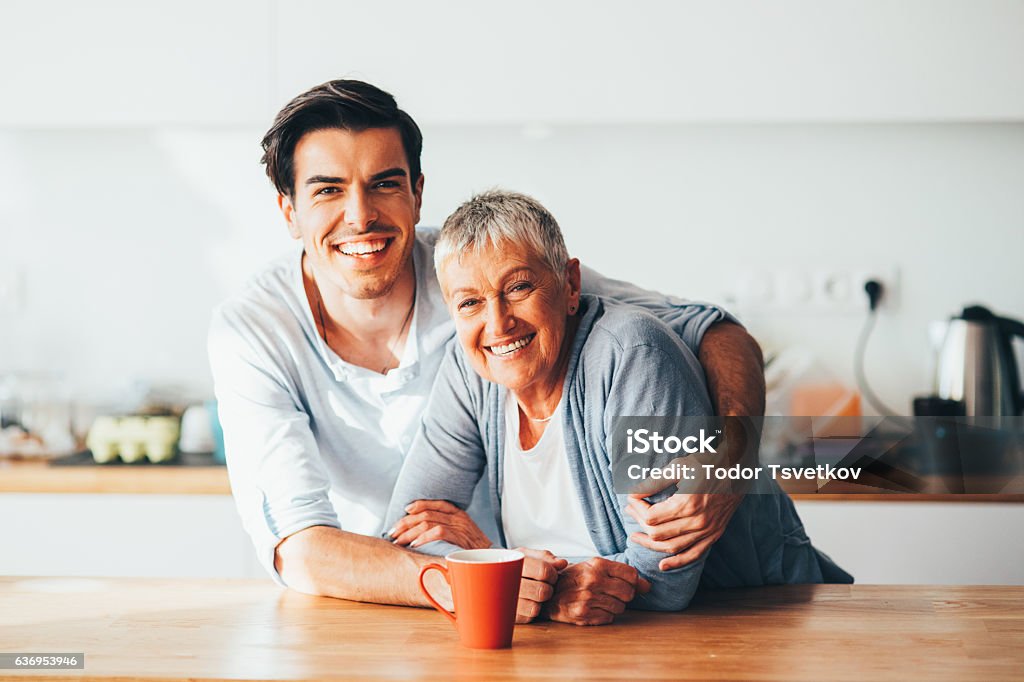 Mother and son Happy portrait of mother and son in the kitchen. Mother Stock Photo