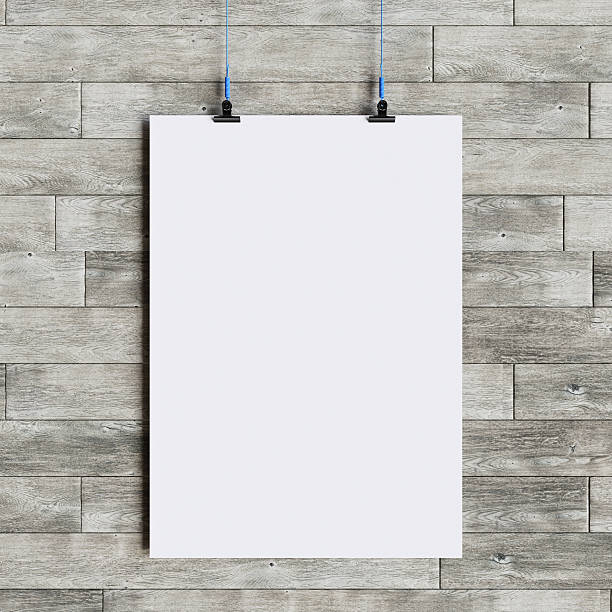 istock Paper blank poster template hanging over wall. 3D illustration 636954394