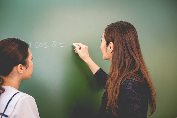 istock Female Student and Teacher Doing Math, Hong Kong School, China 636956066