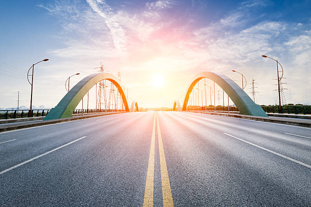 istock countryside asphalt road at sunset 636960286