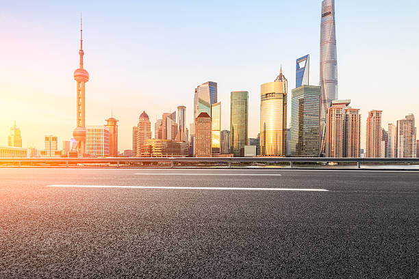 istock Asphalt road and modern cityscape at sunset in Shanghai 636961892
