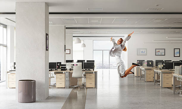 istock Dancing businesswoman in office room . Mixed media 636961896
