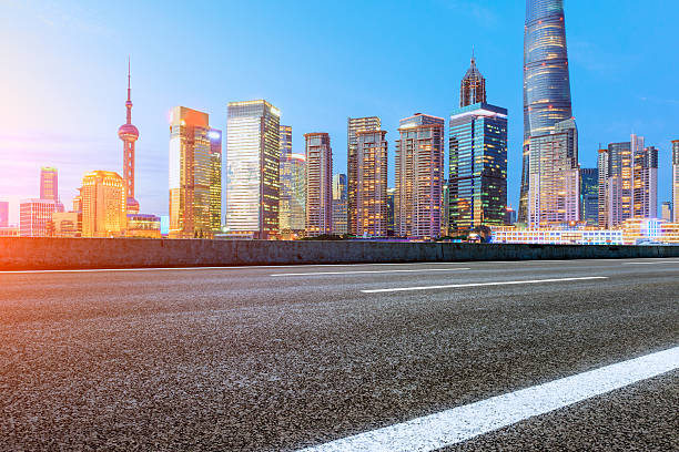 istock Asphalt road and modern cityscape at sunset in Shanghai 636961992