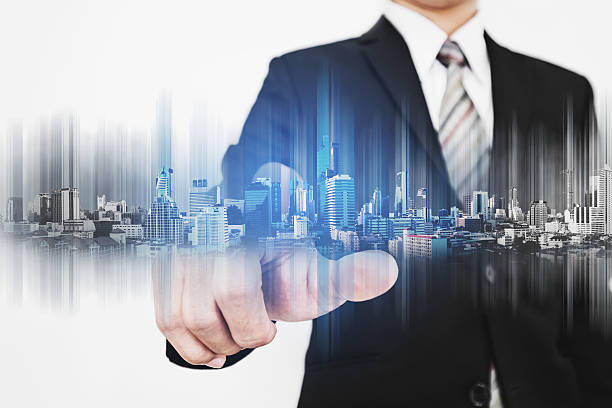 istock Businessman pointing finger to screen, with technology graphic modern buildings 636962270