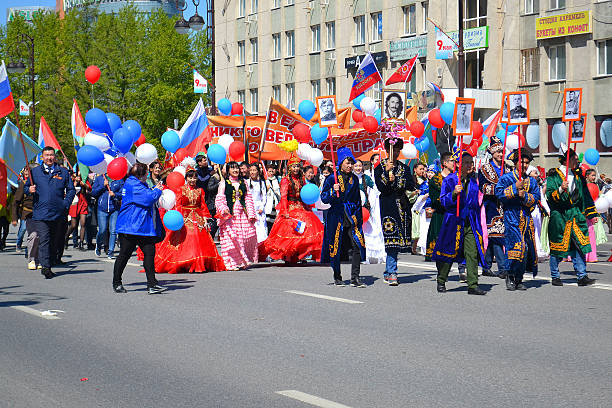 Tyumen, Russia -  May 9, 2016: People in national suits participate in demonstration in honor of the Victory Day on May 9, 2016. 