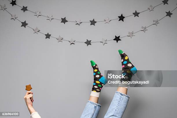 Womens Legs In Funny Socks On A Gray Background Stock Photo - Download Image Now - Sock, Christmas, Multi Colored