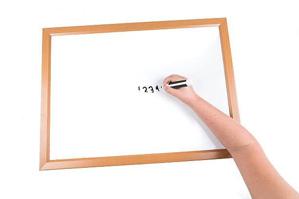 istock Child writing on a dry erase board with a marker 636964706