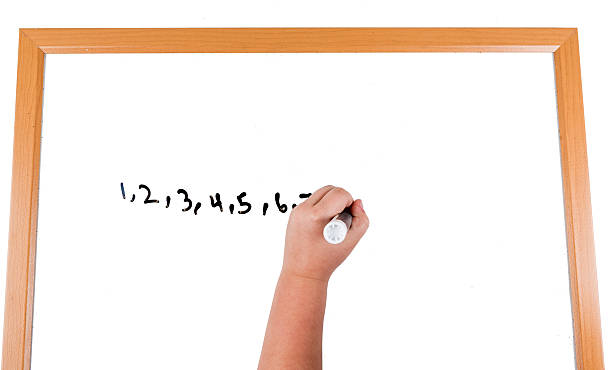 istock Child writing on a dry erase board with a marker 636964712