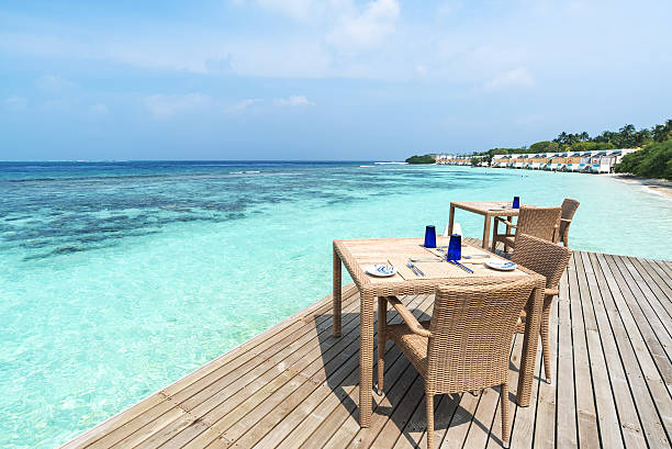 istock Restaurant tables and chairs on the sea view terrace 636964836