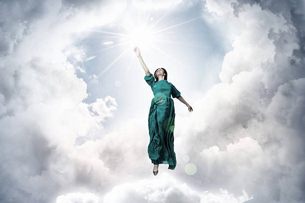 istock Woman levitating in sky . Mixed media 636964858