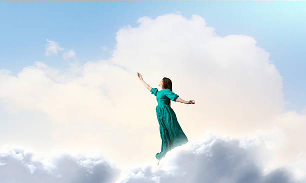 istock Woman levitating in sky . Mixed media 636965066
