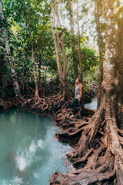 istock Woman standing in forest near the blue river 636965974