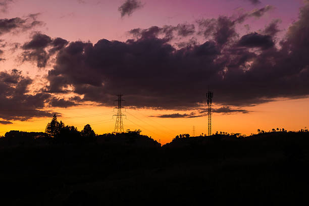istock silhouette of high voltage and telephone pole during sunset 636966702