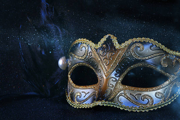 istock black venetian mask on glitter background 636967098