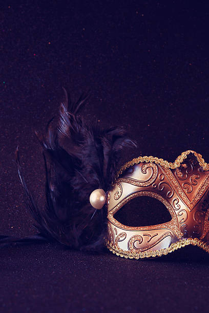 istock black venetian mask on glitter background 636967284