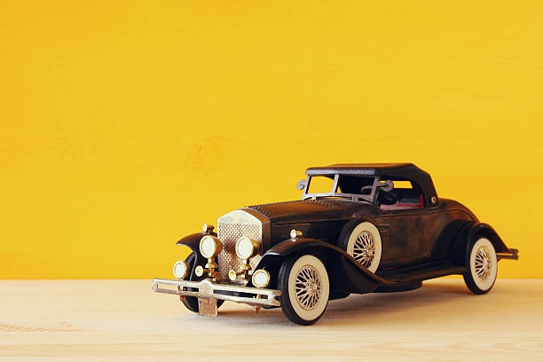 istock Vintage toy car over wooden table 636967612