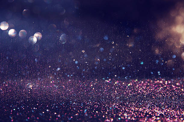 istock glitter purple and silver lights background 636968914