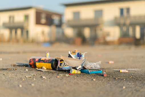 Hennersdorf, Austria - January 1, 2017: firework leftovers on road new years day background blurred, semi-detached houses