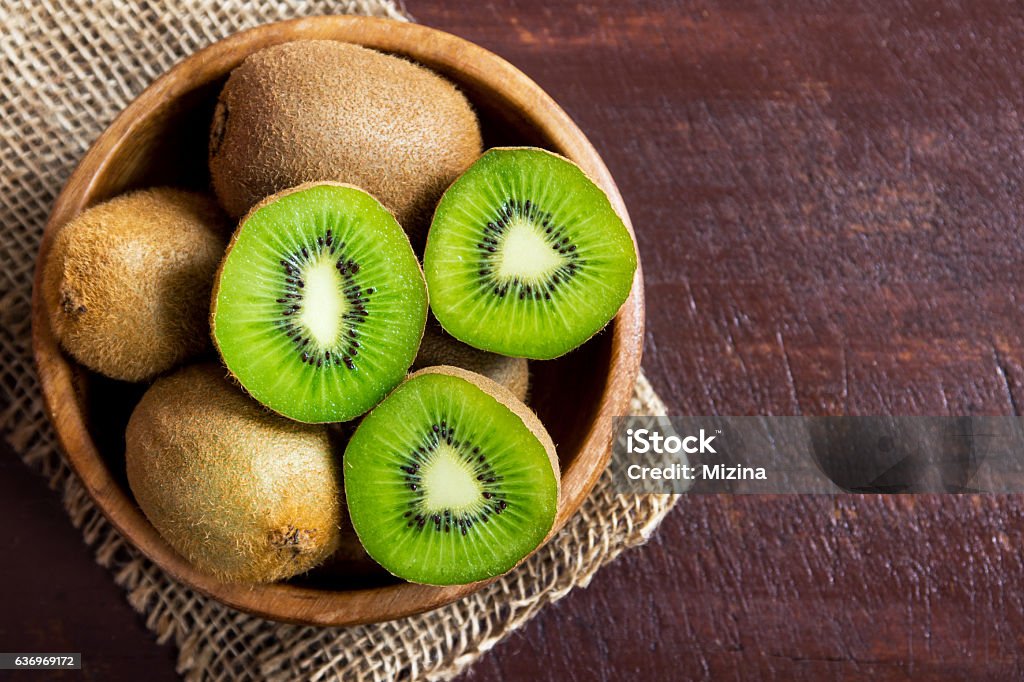 Kiwi fruit Kiwi fruit on wooden background with copy space Kiwi Fruit Stock Photo