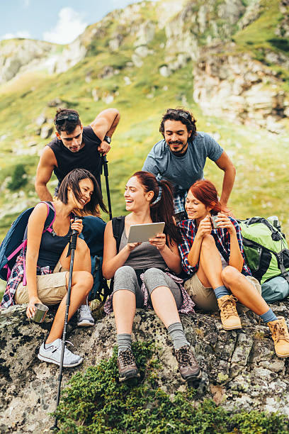 istock Friends browsing the net in the mountain 636969796