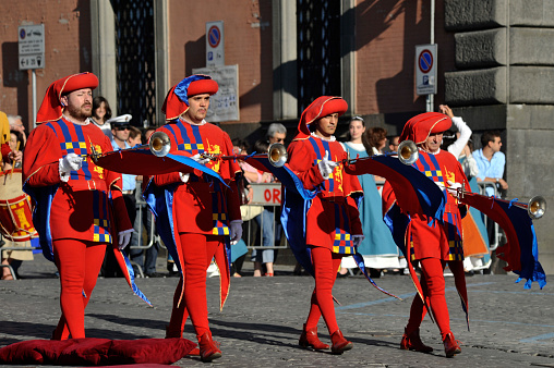 Orvieto, Italy - June 13, 2009: Corpus Domini Day is one of the most important historical displays in Orvieto that takes place in late spring. In this photo, four trumpeters,dressed in medieval garbs, are walking during the parade.