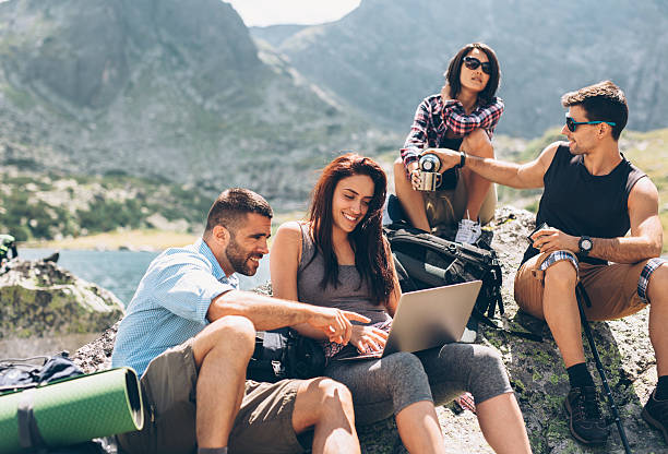 istock Friends browsing the net in the mountain 636969910