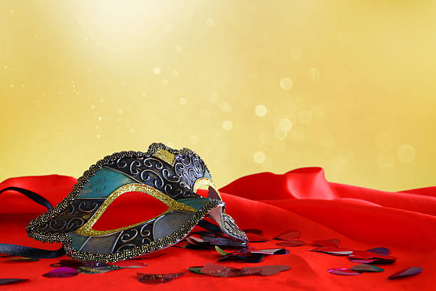 istock elegant venetian mask on red silk 636970596