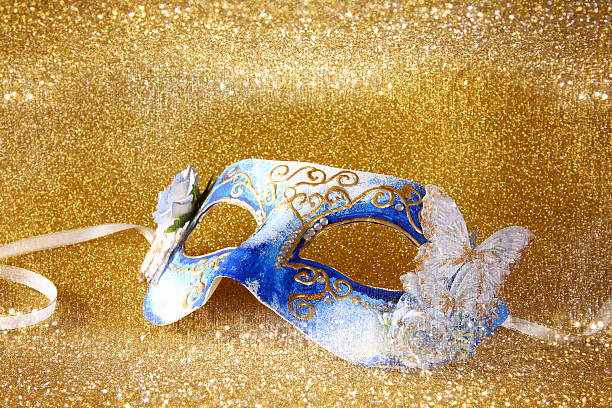 istock elegant venetian mask on gold glitter background 636971832