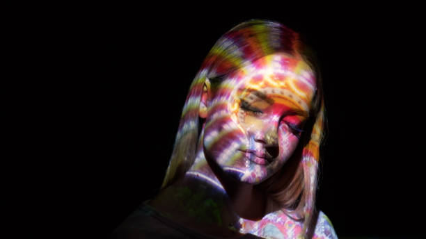 istock Amusement park lights on a woman's face 636972220