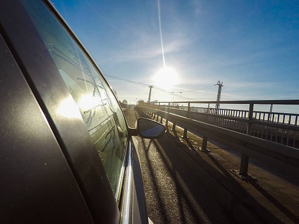 istock car driving on a asphalt road with blue sky 636973606