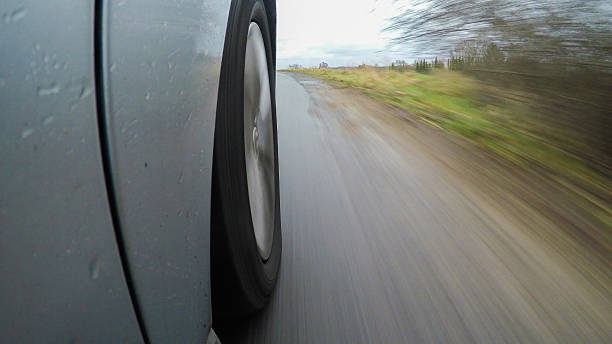 istock car driving on a  asphalt  road with motion blurr 636974262
