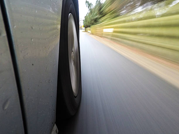 istock car driving on a  asphalt  road with motion blurr 636975206