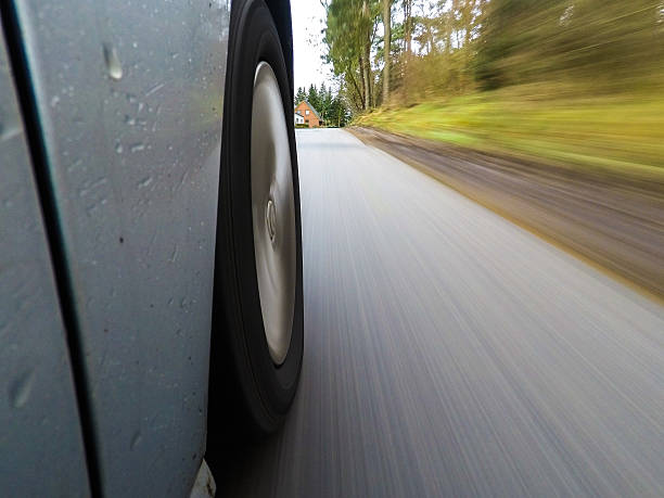 istock car driving on a  asphalt  road with motion blurr 636975292