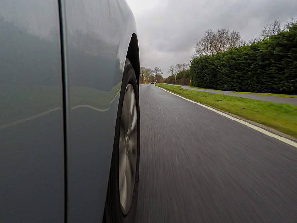 istock car driving on a  asphalt  road with motion blurr 636975620