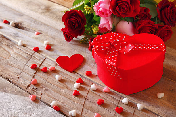 istock Red hearts and present box on wooden table 636976064
