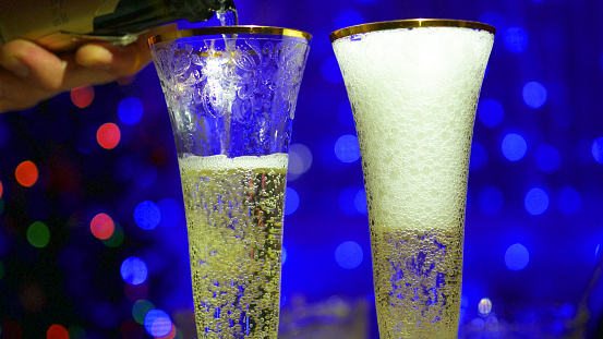 sparkling wine is poured into glasses