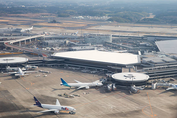 Narita International Airport in Japan Narita, Japan - December 26, 2016 : Airplanes parked at the Narita International Airport, Chiba, Japan. It is the second busiest airport in Japan. narita japan stock pictures, royalty-free photos & images