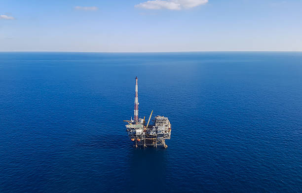 Image of oil platform while cloudless day - aerial view Image of oil platform while cloudless day - aerial view fuel and power generation oil industry oil rig industry stock pictures, royalty-free photos & images