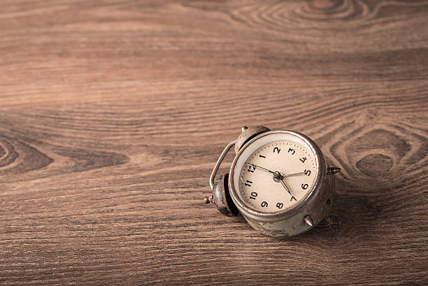 istock Vintage, old alarm clock on wooden 636978198