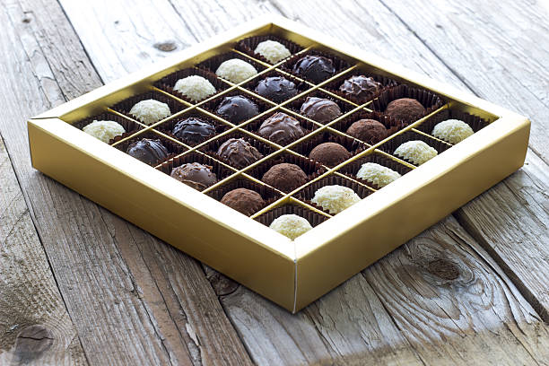 Chocolates in box on wooden